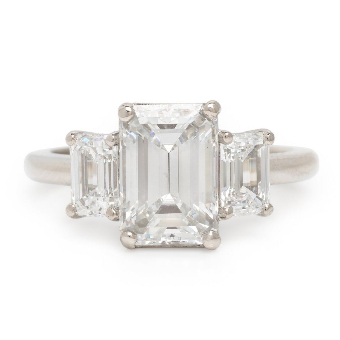 Emerald Cut Diamond and Platinum Ring: Emerald Cut Diamond and Platinum Ring Featuring a central emerald cut diamond weighing 2.37 carats, and flanked by two emerald cut diamonds weighing approximately 1.03 carats total. Mounted in platinu