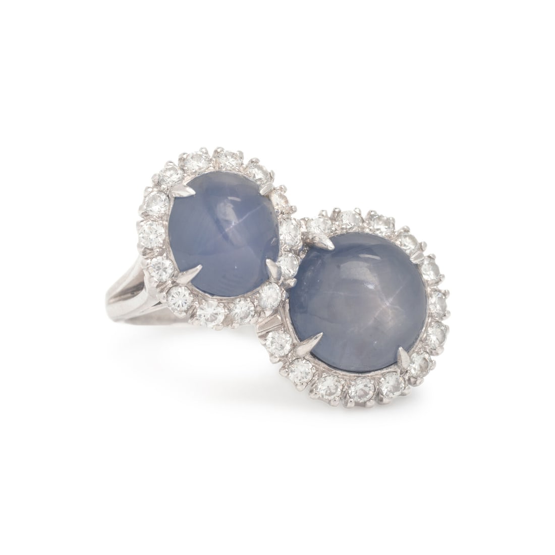 Spaulding & Co., Star Sapphire, Diamond, and Platinum Ring: Spaulding & Co., Star Sapphire, Diamond, and Platinum Ring Featuring two round cabochon star sapphires weighing approximately 8.35 carats and 3.40 carats by formula respectively, and round brilliant c