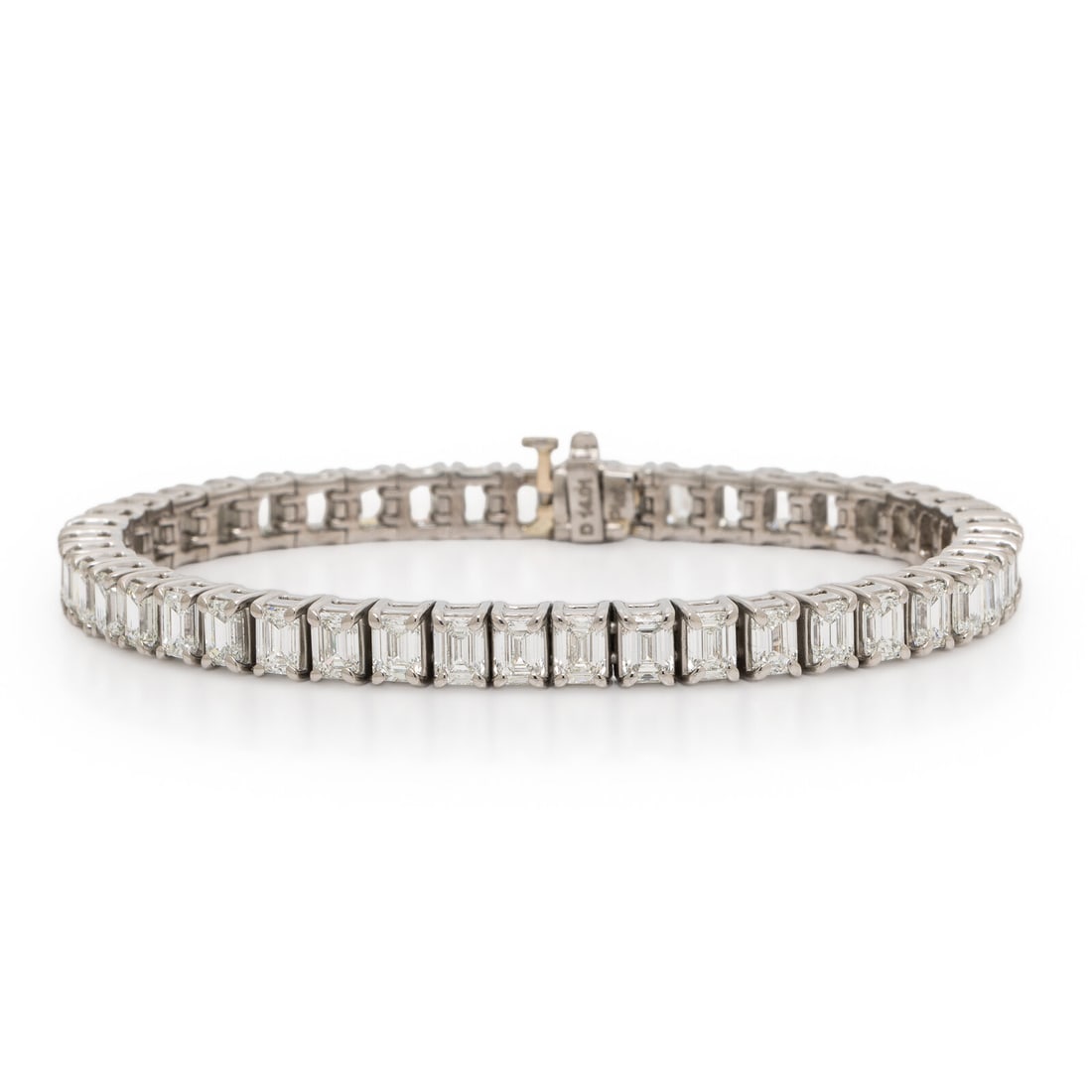 Diamond and Platinum Line Bracelet: Diamond and Platinum Line Bracelet Set with emerald cut diamonds weighing approximately 14.01 carats total. Mounted in platinum. 7 inches long. Stamp: D 14.01 Plat. Gross weight: 23.85 dwt. Accompanie