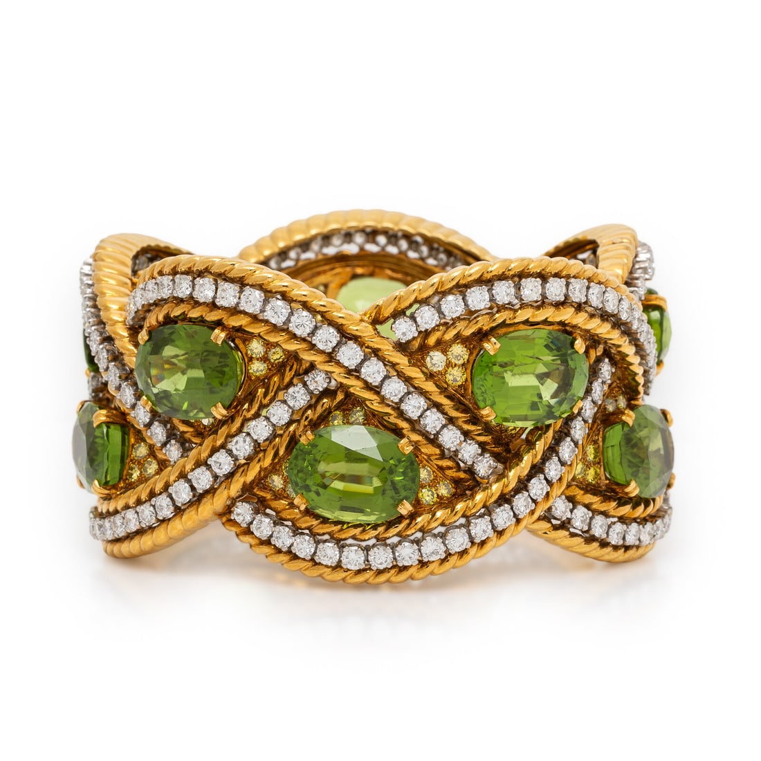 Verdura, Peridot, Diamond, Colored Diamond, and Yellow Gold Bracelet: Verdura, Peridot, Diamond, Colored Diamond, and Yellow Gold Bracelet In a braided design, set with ten oval peridots weighing approximately 78.50 - 91.50 carats total by formula, round brilliant cut d