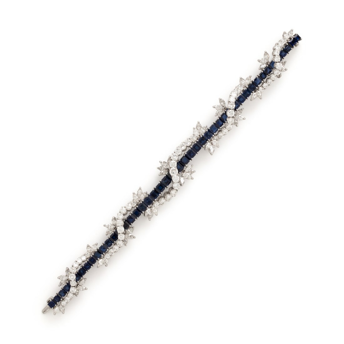 Diamond, Sapphire, and Platinum Bracelet: Diamond, Sapphire, and Platinum Bracelet In a twisted foliate design, set with round brilliant and marquise cut diamonds weighing approximately 8.00 - 10.00 carats total, and square step cut