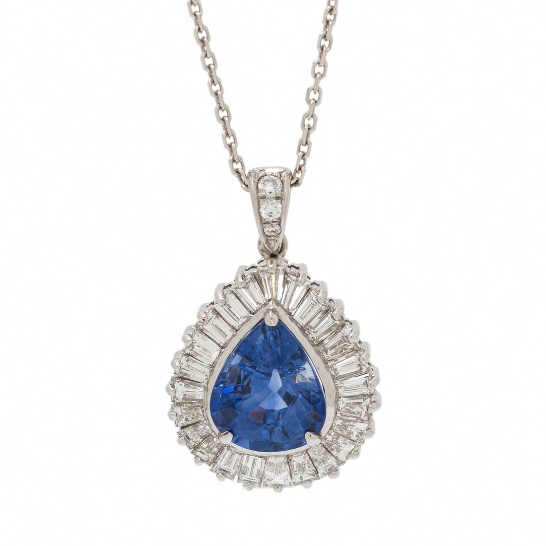 Sapphire, Diamond, and White Gold Pendant Necklace: Sapphire, Diamond, and White Gold Pendant Necklace A pear shape sapphire weighing approximately 5.11 carats, set in a ballerina pendant with tapered baguette and round brilliant cut diamonds weighing