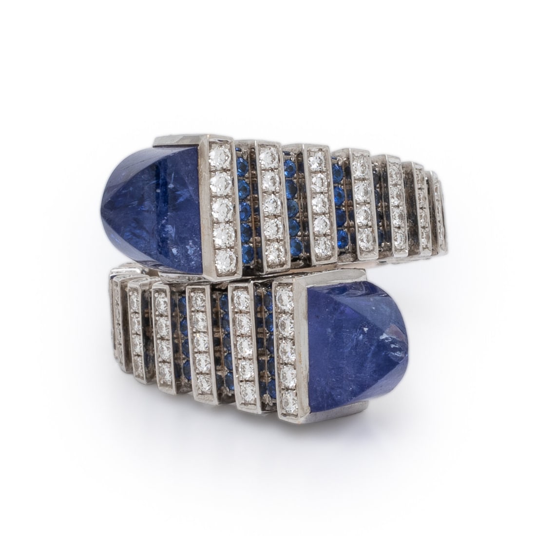 Marli, 'Cleo Jazz', Tanzanite, Sapphire, Diamond, and White Gold Ring: Marli, 'Cleo Jazz', Tanzanite, Sapphire, Diamond, and White Gold Ring In a geometric bypass design, set with round brilliant cut diamonds weighing approximately 0.70 carat total, round sapphires, and