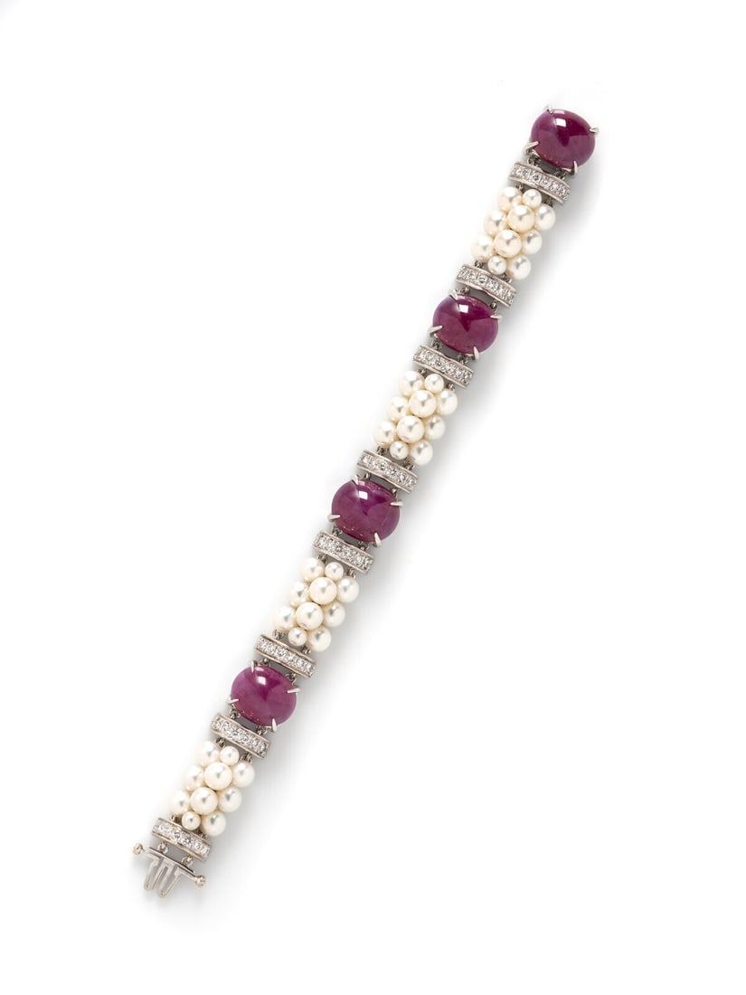 Seaman Schepps, Ruby, Cultured Pearl, and Diamond Bracelet: Seaman Schepps, Ruby, Cultured Pearl, and Diamond Bracelet Set with four oval cabochon rubies weighing approximately 50.00 - 55.00 carats total by formula, cultured pearls measuring approximately