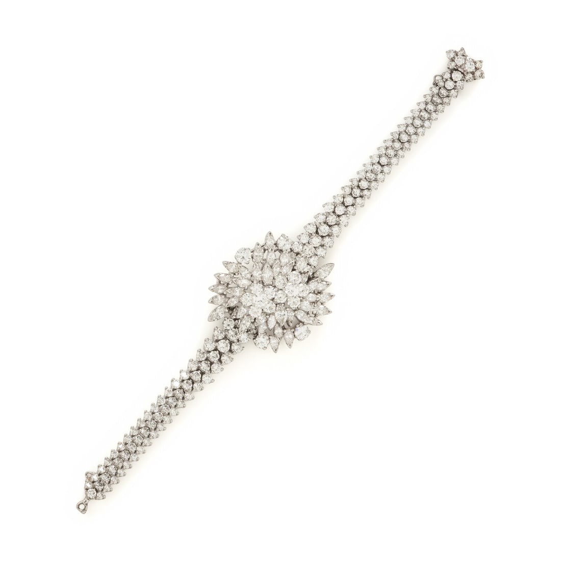 Diamond and Platinum Bracelet: Diamond and Platinum Bracelet Designed with a central cluster on a three row diamond bracelet, set throughout with round brilliant and marquise cut diamonds weighing approximately 12.00 - 15.00