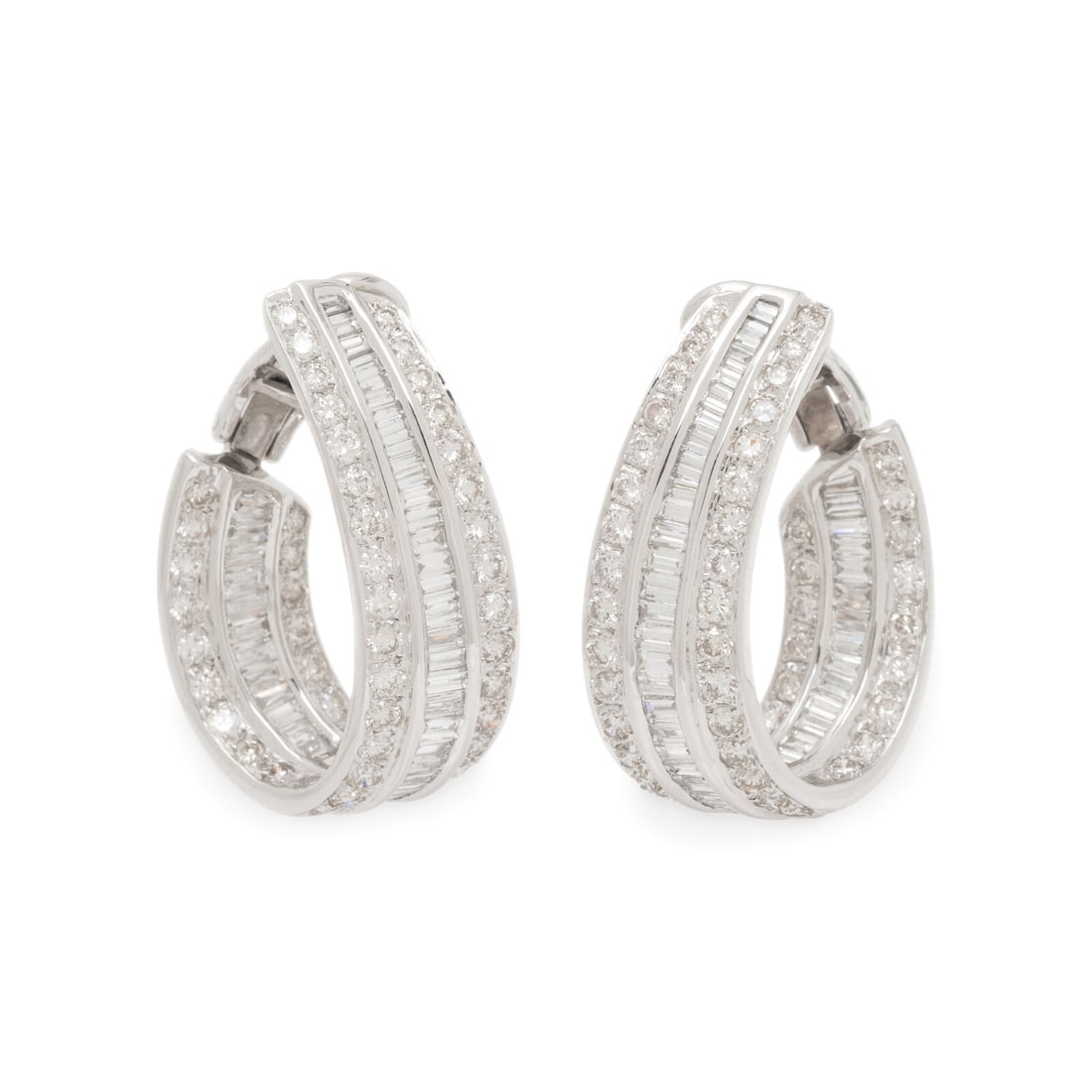 Platinum and Diamond Hoop Earrings: Platinum and Diamond Hoop Earrings Designed as three rows of alternating round and baguette cut diamonds weighing approximately 6.50 carats total. Mounted in platinum. 1 3/8 inches long. Stamp: