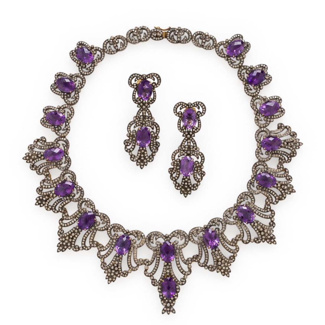 Amethyst, Colored Diamond, and Silver-Topped Gold Set: Amethyst, Colored Diamond, and Silver-Topped Gold Set Including a pair of girandole earrings and a necklace, each designed with scrolling motifs, set with checkerboard-faceted oval amethysts, and roun