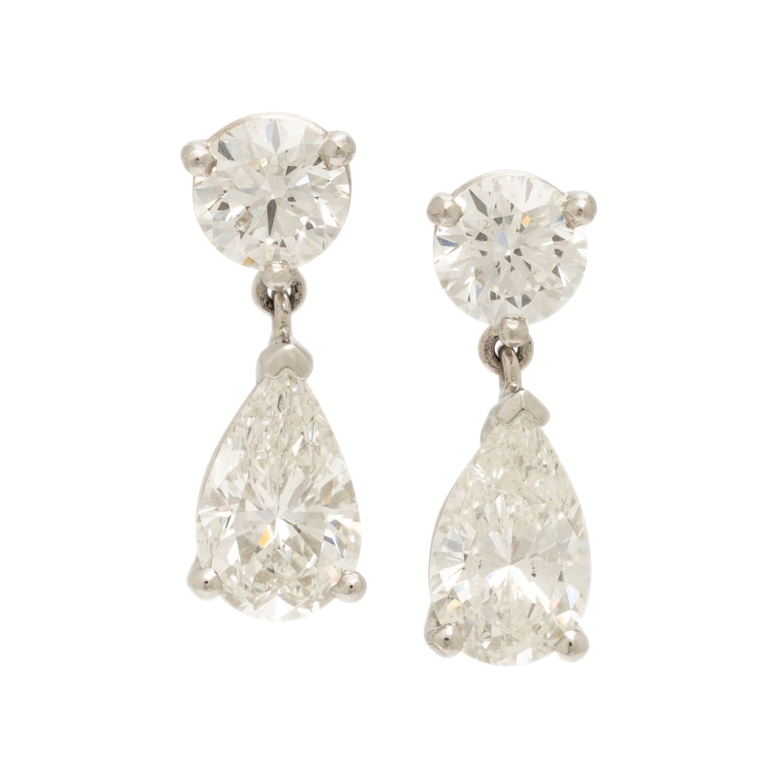 Diamond Drop Earrings: Diamond Drop Earrings Set with two pear shape diamonds weighing 1.66 and 1.57 carats respectively, suspended from round brilliant cut diamonds weighing approximately 1.60 carats total. Mounted in plat