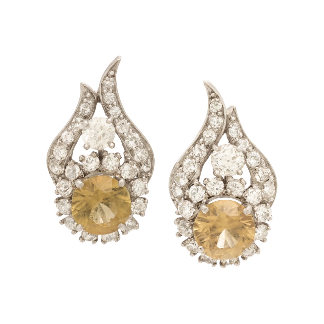 Sinhalite, Diamond, and Platinum Earrings: Sinhalite, Diamond, and Platinum Earrings Featuring round sinhalite surrounded by old European and transitional cut diamonds weighing approximately 2.30 carats total. Mounted in platinum. 1 inch