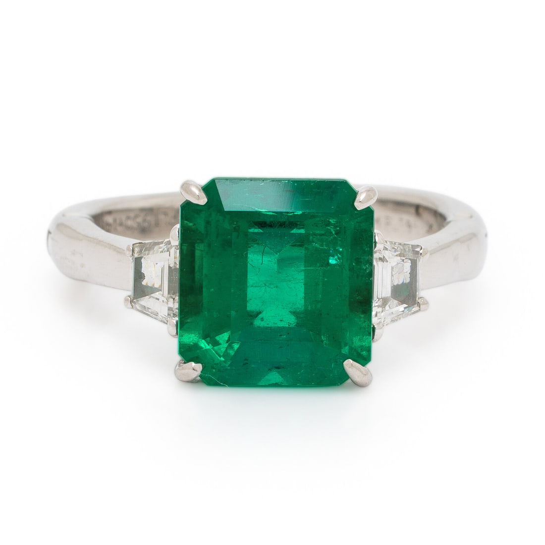Colombian Emerald, Diamond, and Platinum Ring: Colombian Emerald, Diamond, and Platinum Ring Featuring an emerald cut emerald weighing approximately 4.00 carats by formula, set with a trapezoid cut diamond on either side. Mounted in platinum and w