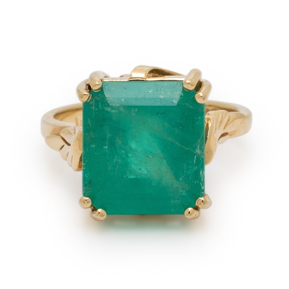 Emerald and Yellow Gold Ring: Emerald and Yellow Gold Ring Set with an emerald cut emerald weighing approximately 7.00 carats by formula. Mounted in 14 karat yellow gold. Ring size 6 3/4. Stamp: (maker's mark) 14K. Gross weight: