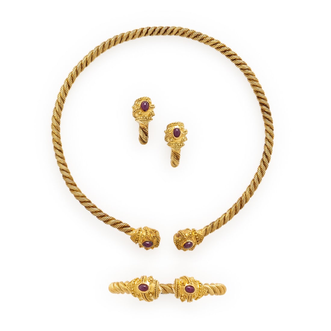 Etruscan Revival Style Ruby and Yellow Gold Jewelry Suite: Etruscan Revival Style Ruby and Yellow Gold Jewelry Suite Including a flexible torque necklace, cuff bracelet, and earrings, with applied bead and wire twist accents each set with two oval cabochon ru