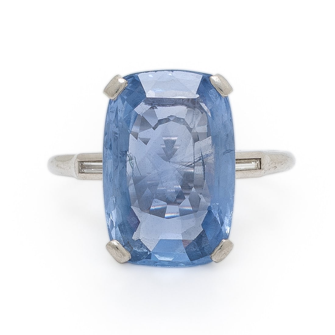 Ceylon Sapphire and Diamond Ring: Ceylon Sapphire and Diamond Ring Set with a cushion cut sapphire weighing approximately 5.90 carats by formula, accented by baguette cut diamonds in the shoulders. Mounted in platinum. Ring size 4 3/4