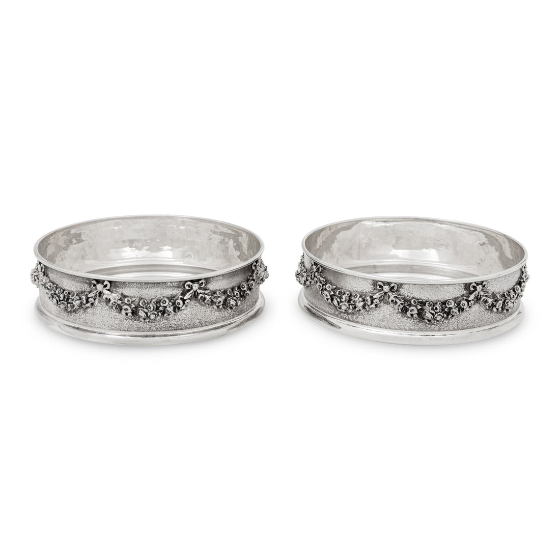 A Pair of Greek Silver Bottle Coasters: A Pair of Greek Silver Bottle Coasters Mathaios Armaos, 20th Century together with a fitted case. each coaster marked with '925' standard to the underside 16 ozt 12 dwt Height 1 1/2 x diameter 5 5/8