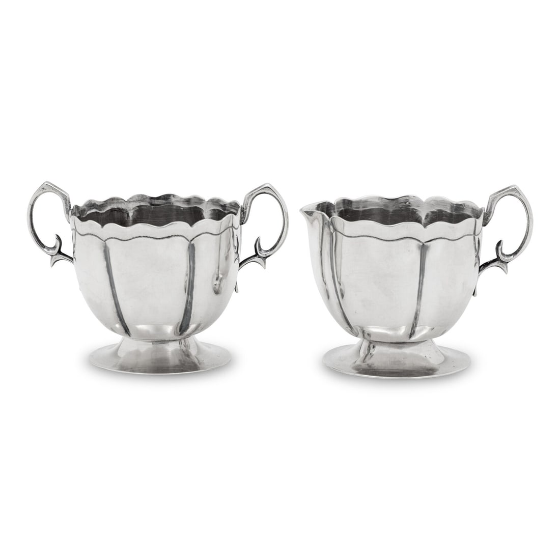 A Mexican Silver Creamer and Sugar Set: A Mexican Silver Creamer and Sugar Set L. Maciel, Mexico City, Mid 20th Century each marked '925' and 'Sterling' on underside 9 ozt 9 dwt Height of creamer 3 1/8 x width 4 inches. This lot is located 