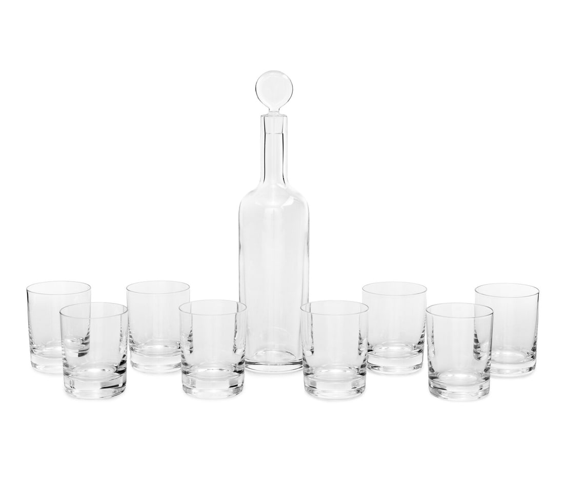 A Baccarat Bar Service: A Baccarat Bar Service each marked to underside, comprising a decanter with stopper and a set of eight tumblers; 9 pieces total. Overall height of decanter 14 inches. This lot is located in Chicago.