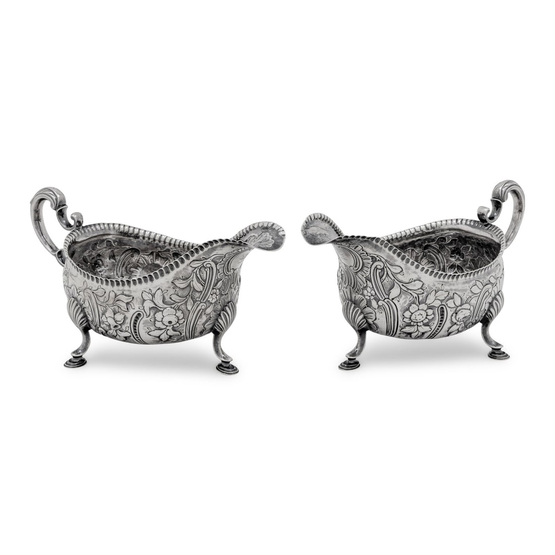 A Pair of Irish George III Silver Sauce Boats: A Pair of Irish George III Silver Sauce Boats Charles Marsh, Dublin, Early 19th Century each hallmarked for Sterling to the underside 22 ozt 7 dwt Height 4 1/2 x width 9 x depth 4 1/4 inches. Property