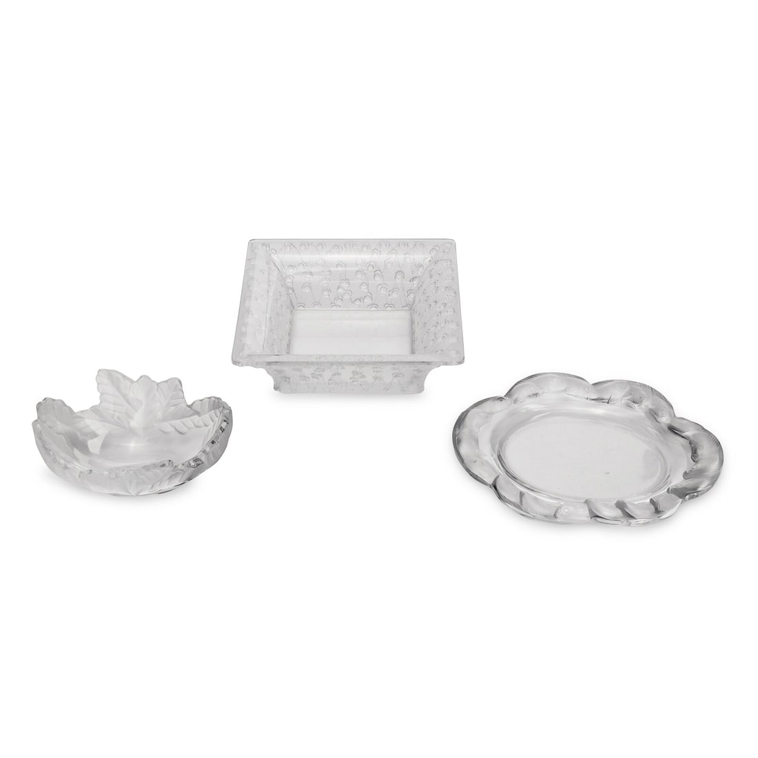 Three Lalique Table Articles: Three Lalique Table Articles Second Half 20th Century each signed Lalique France to underside, comprising a Compeigne dish, Roses bowl, and Andromeda vase. Height of Roses bowl 3 1/4 x width 9 5/8 x d