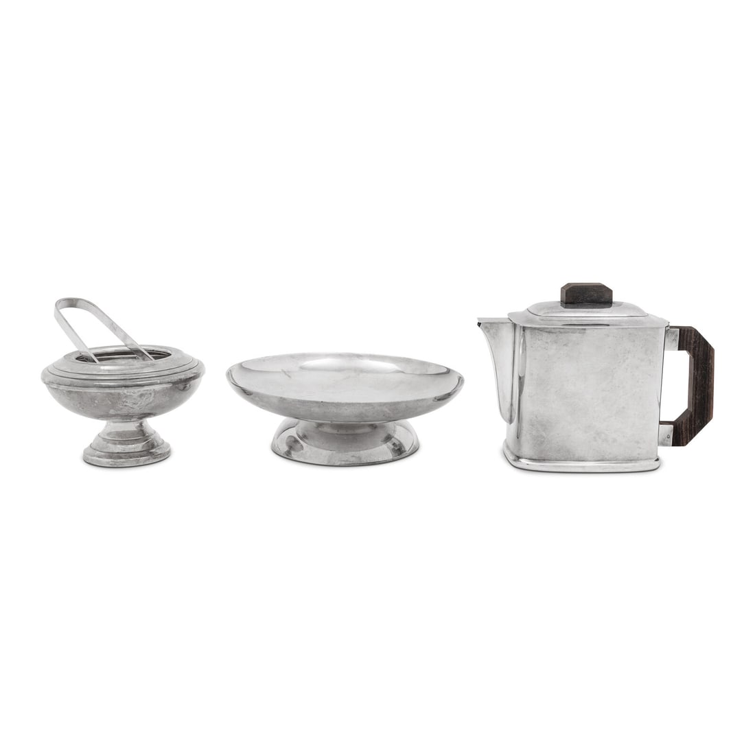 A Group of Three Ercuis Silver-Plate Table Articles: A Group of Three Ercuis Silver-Plate Table Articles 20th Century comprising a teapot with wood handle, a pedestal bowl, and a sugar bowl with tongs. Height of teapot 5 1/2 inches. This lot is located