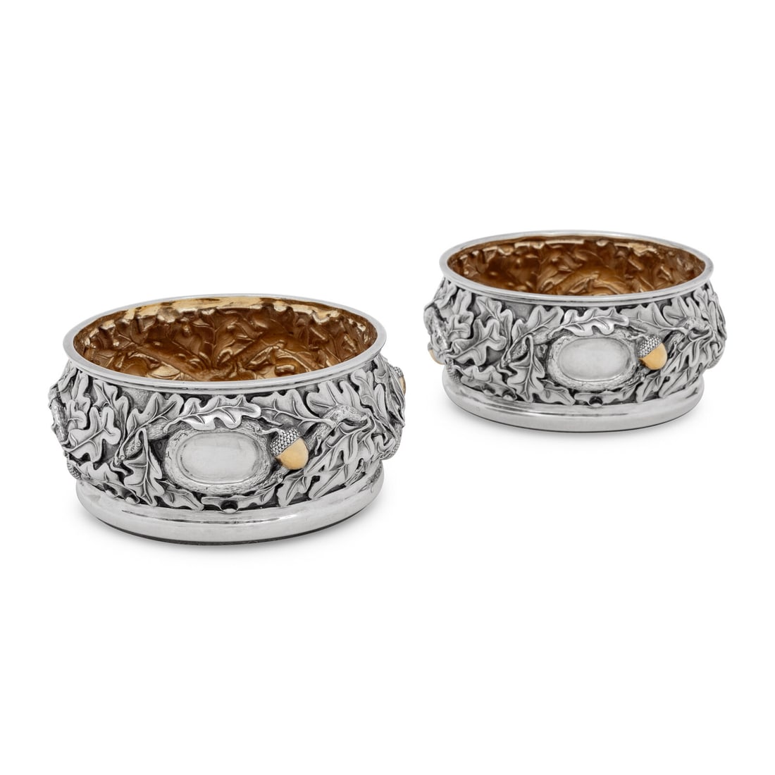 A Pair of American Silver Bottle Coasters: A Pair of American Silver Bottle Coasters By Robert Butler, Modern each marked 'Sterling' to the side of the body; the interiors silver gilt and the bases wood. Height 2 3/4 x diameter 5 1/2 inches