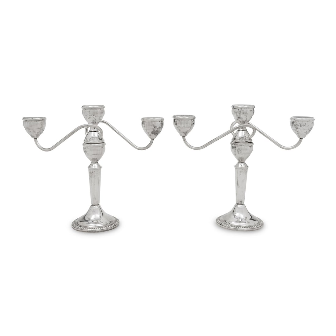 A Pair of American Silver Three-Light Candelabra: A Pair of American Silver Three-Light Candelabra Duchin Creation, Second Half 20th Century New York, each marked 'Sterling' and 'Weighted' to the underside Height 9 1/2 x width 11 inches. Property