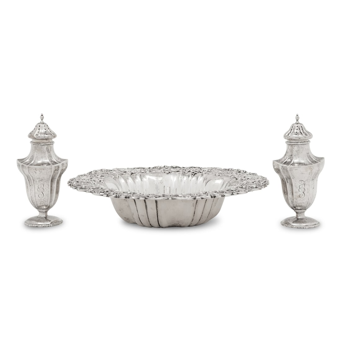 A Group of Three American Silver Articles: A Group of Three American Silver Articles Various Makers, 20th Century retailed by Cowell and Hubbard Co., comprising a pierce decorated bowl and pair of casters. each marked 'Sterling' to underside