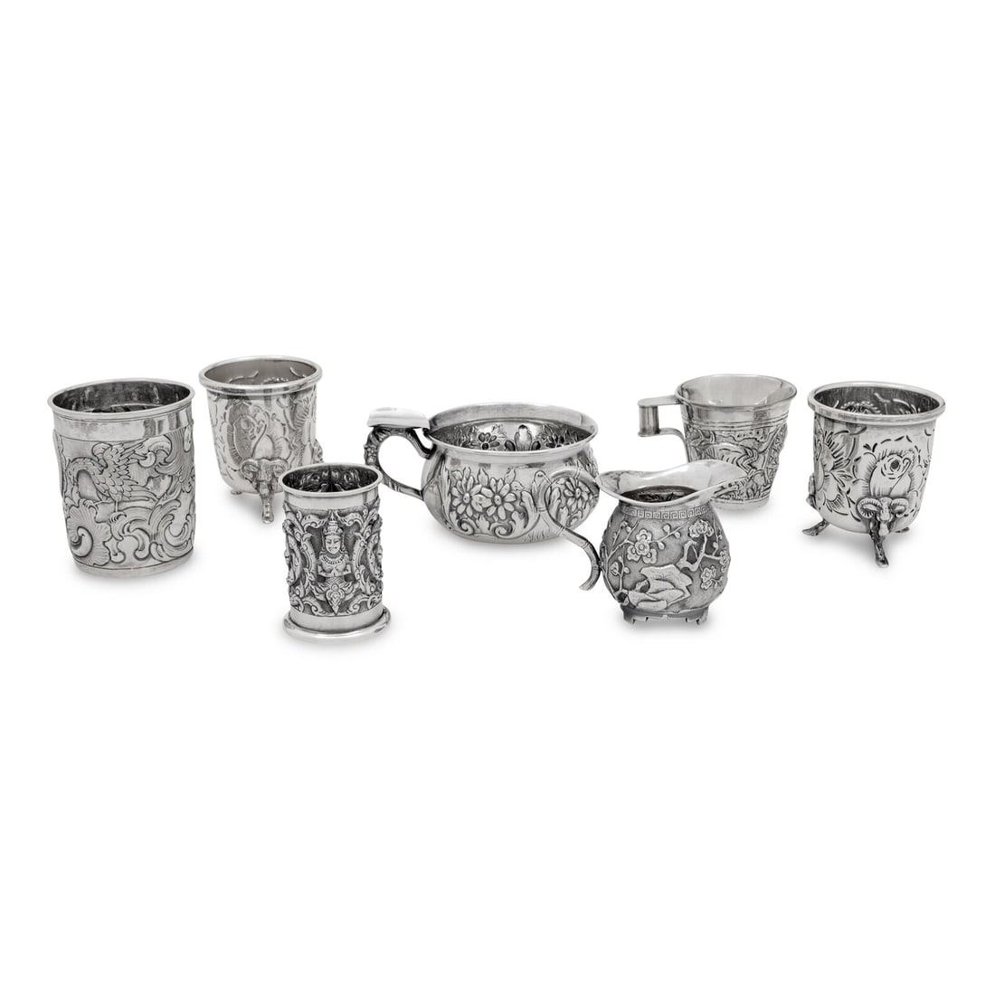 A Collection of Silver Repousse Decorated Table Articles: A Collection of Silver Repousse Decorated Table Articles comprising a pair of American toothpick holders, a Thai toothpick holder by Alex and Co., a espresso cup stamped 900, and American handled