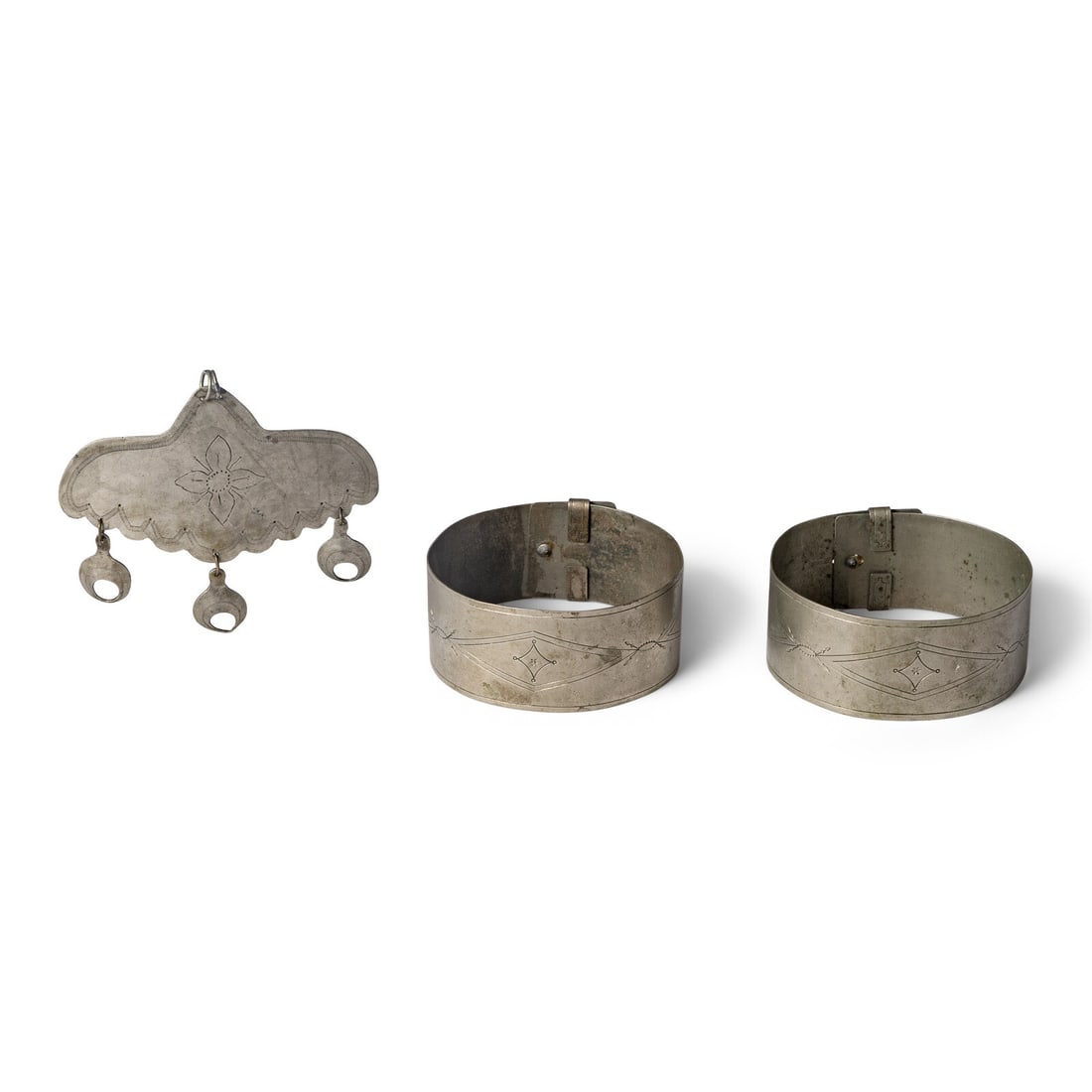 Southern Plains German Silver Pectoral and Armbands: Southern Plains German Silver Pectoral and Armbands late 19th century lot of 2, includes: a rocker-engraved pectoral, length 3-1/2 inches x width 4-1/4 inches a pair of engraved armbands, diameter 3-1