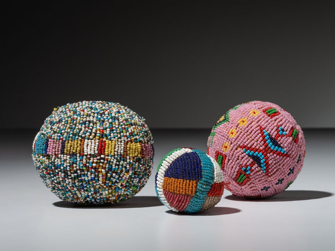 Sioux Beaded Game Balls: Sioux Beaded Game Balls first half 20th century group of three, includes one with salt and pepper beadwork; another with blocks of colors; and the third having a pink ground diameters 3-1/2 inches, 3 