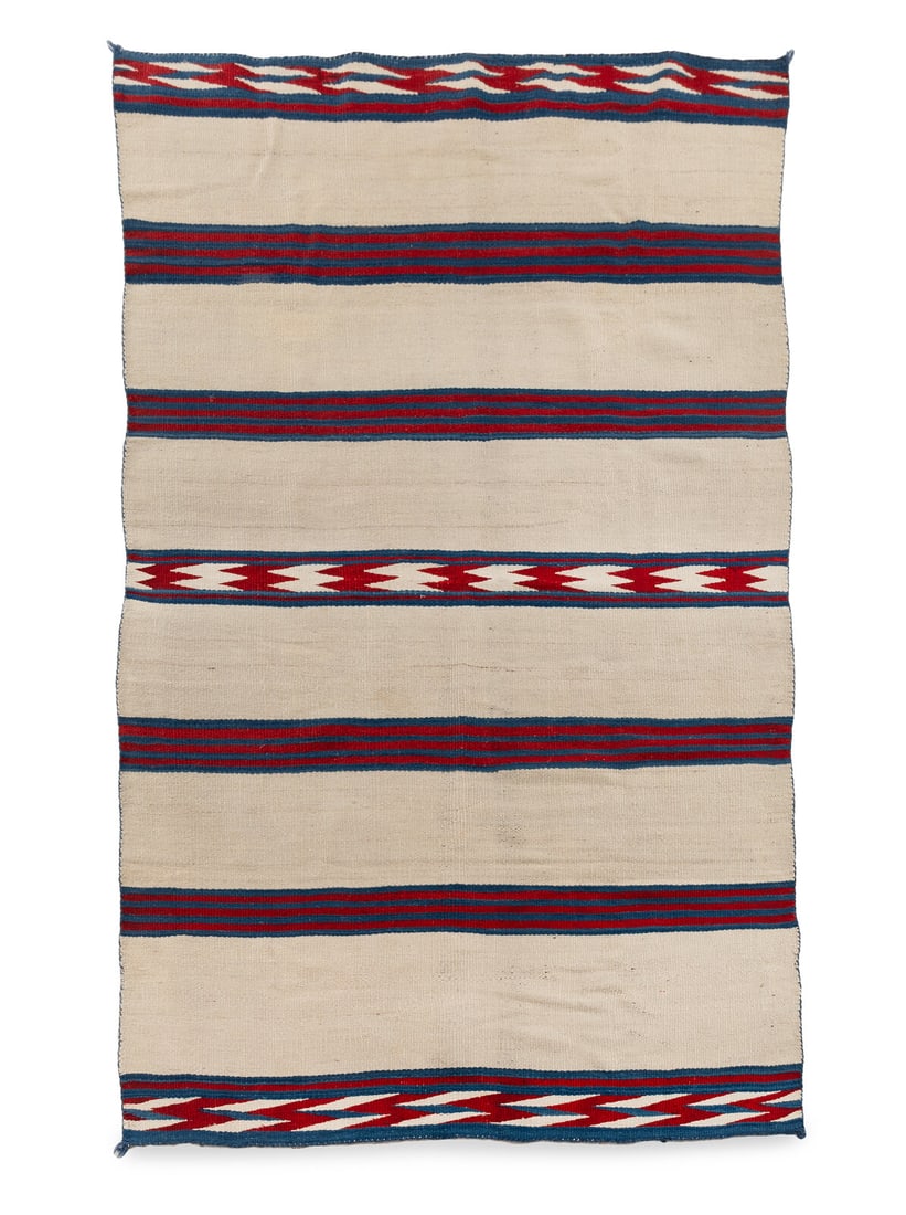 Navajo Classic Wearing Blanket: Navajo Classic Wearing Blanket ca 1860 soft, handspun wool woven with natural brown wool warps and cochineal-dyed raveled bayeta, indigo, and cream; banded design 80 x 46 inches This elegant textile w