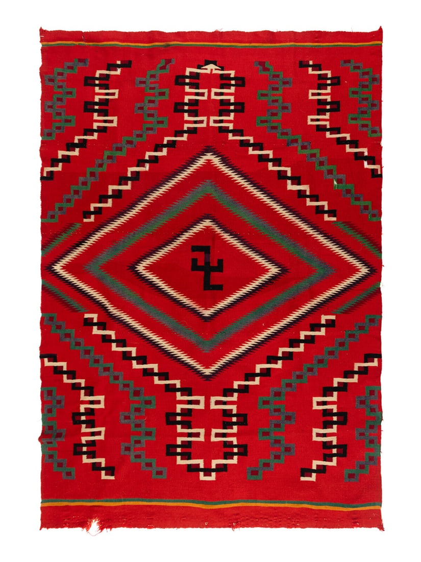 Navajo Germantown Weaving [Rug]: Navajo Germantown Weaving [Rug] ca 1900 woven with colors of red, green, cream, black, yellow, blue, and maroon; serrated diamond contains a central whirling log 64 x 46 inches The Ronny and Doris