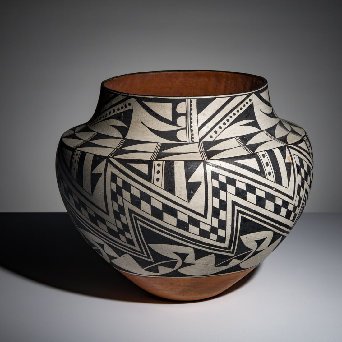 Jessie Garcia (Acoma, 1910-1999) Black-on-White Pottery Jar: Jessie Garcia (Acoma, 1910-1999) Black-on-White Pottery Jar elegant form with geometric designs on the body; horizontal band at the shoulder enforces its sharp shoulder; signed on base height 11-1/2 i