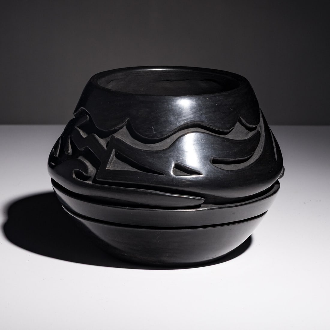 Teresita Naranjo (Santa Clara, 1919-1999) Carved Blackware Pottery Jar, Avanyu: Teresita Naranjo (Santa Clara, 1919-1999) Carved Blackware Pottery Jar, Avanyu signed on base height 5-3/4 inches x diameter 8 inches This lot is located in Chicago.