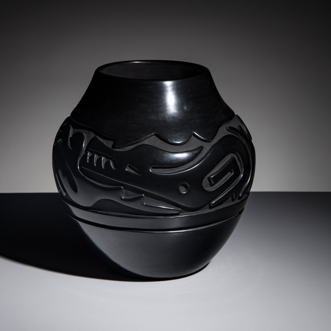 Teresita Naranjo (Santa Clara, 1919-1999) Carved Blackware Pottery Jar: Teresita Naranjo (Santa Clara, 1919-1999) Carved Blackware Pottery Jar large form, with body carved in the form of a slithering Avanyu; signed on base height 10 inches x diameter 10-1/4 inches R. Thom