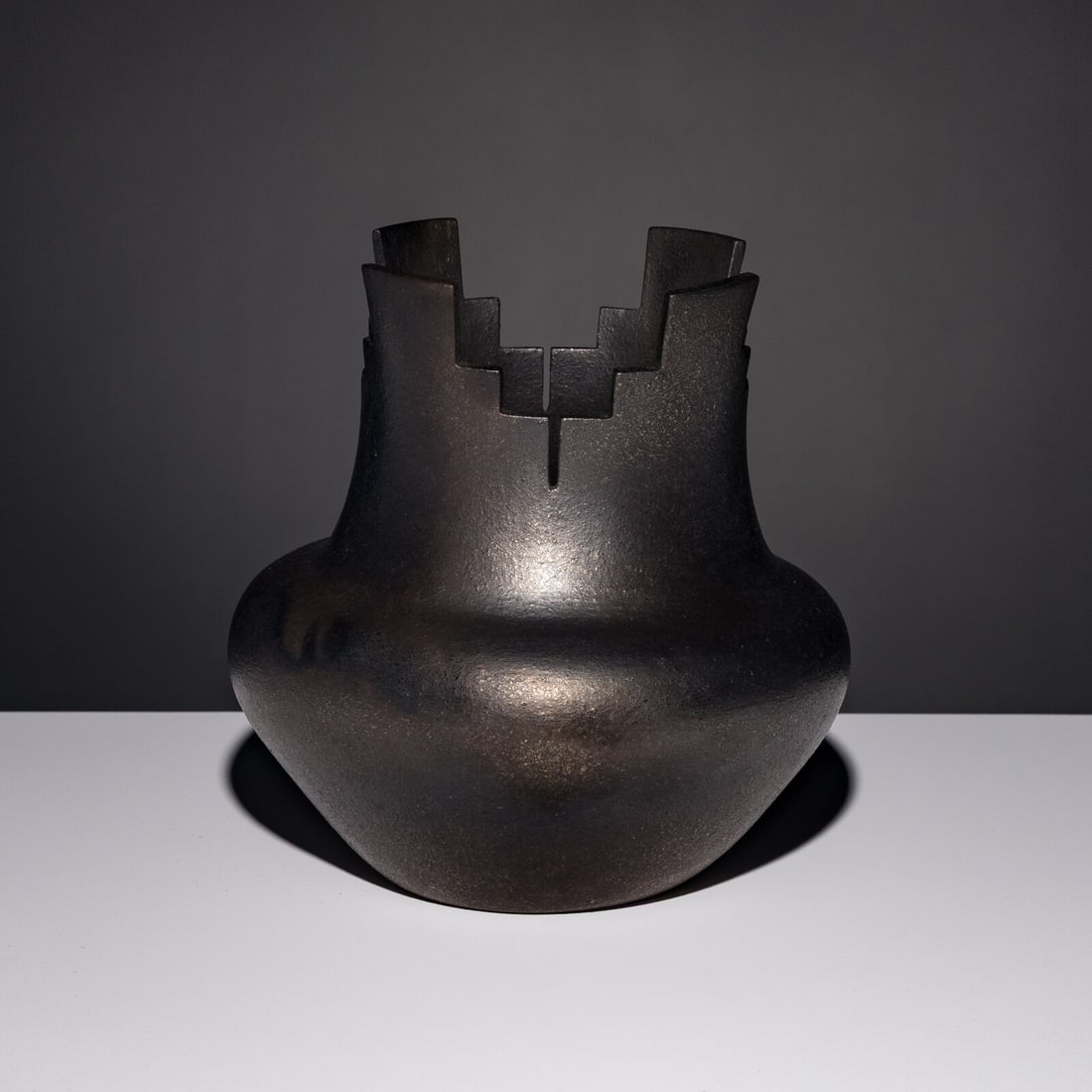 Angie Yazzie (Taos, b. 1965) Micaceous Blackware Pottery Jar, with Terraced Rim: Angie Yazzie (Taos, b. 1965) Micaceous Blackware Pottery Jar, with Terraced Rim signed on base height 7 inches x diameter 7 inches This lot is located in Chicago.