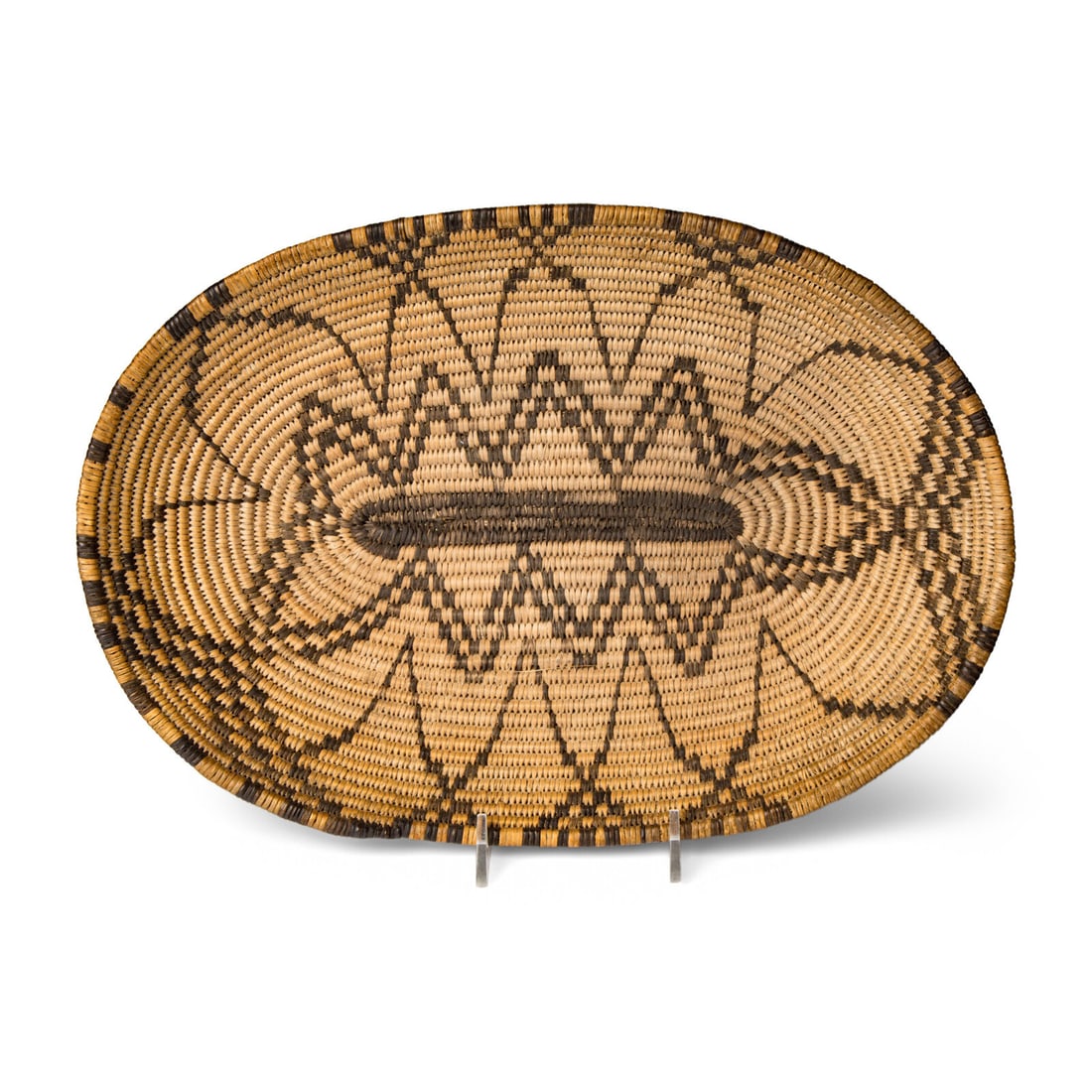 Apache Basket: Apache Basket early 20th century with radiating floral design height 1-3/4 inches x length 12-1/2 inches x width 8-3/4 inches Mrs. Susan Gadpaille Collection This lot is located in Chicago.