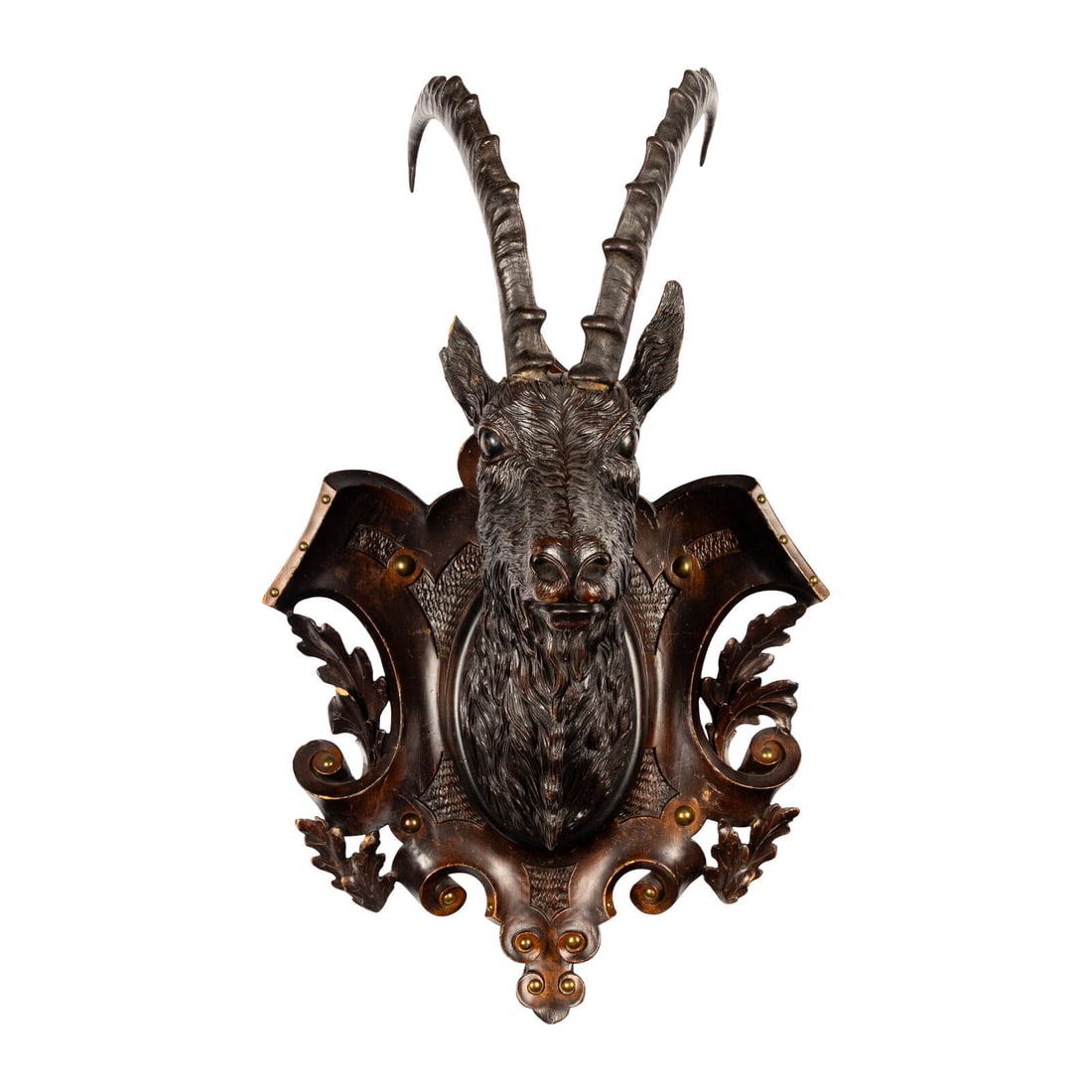 A Swiss "Black Forest" Carved Ibex Mount: A Swiss "Black Forest" Carved Ibex Mount Late 19th Century with applied taxidermy antlers. Height 34 x width 20 1/2 x depth 14 1/2 inches. Property from a Utah Mountain Residence This lot is located
