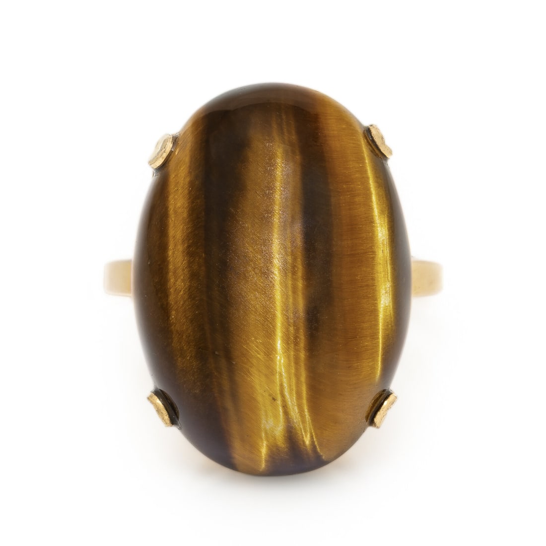 Tiger's Eye Quartz Ring: Tiger's Eye Quartz Ring Oval cabochon tiger's eye weighing approximately 53.20 carats by formula. Low karat gold filled. Ring size 6 3/4. Stamp: 10K G.F. (maker's mark). Gross weight: 5.45 dwt.