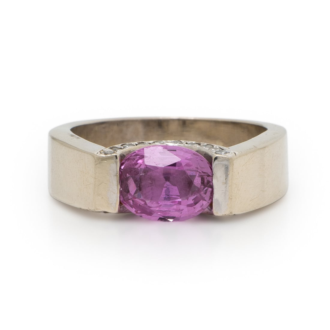 Pink Sapphire, Diamond, and White Gold Ring: Pink Sapphire, Diamond, and White Gold Ring Oval pink sapphire measuring approximately 8.00 x 6.90 mm and round brilliant cut diamonds. 14 karat white gold. Ring size 8. Stamp: 14K. Gross weight:
