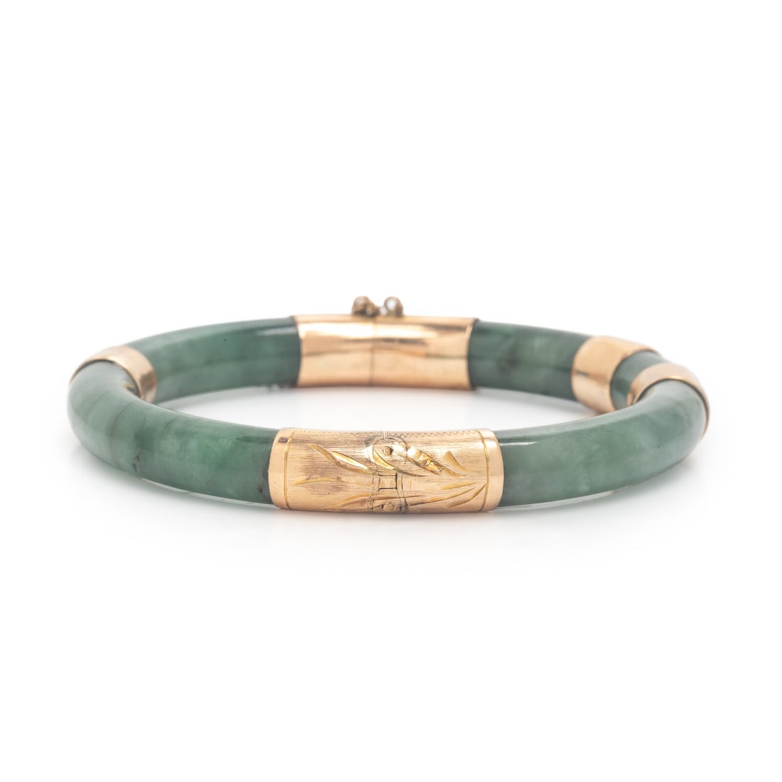 Jade and Yellow Gold Bangle Bracelet: Jade and Yellow Gold Bangle Bracelet Carved jade, hinged with side clasp. 14 karat yellow gold. 6 3/4 inches inner circumference. Stamp: 14K. Gross weight: 24.95 dwt.