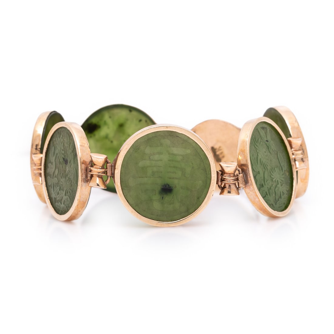Jade and Yellow Gold Bracelet: Jade and Yellow Gold Bracelet Carved jade discs measuring approximately 18.20 x 18.30 x 2.15 mm. 14 karat yellow gold. 7 inches long. Stamp: 14K. Gross weight: 12.90 dwt. From the Collection of Karen 
