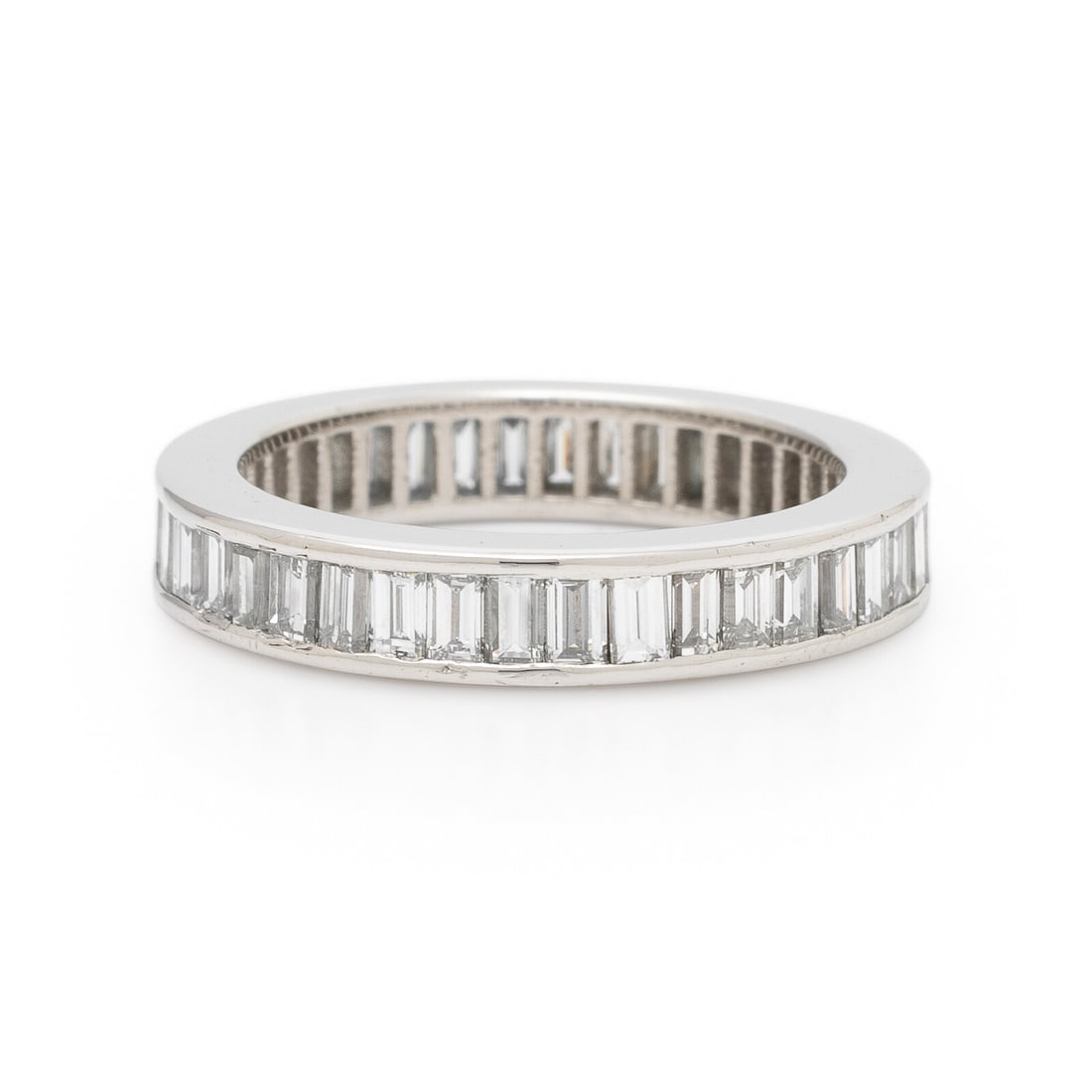 Diamond and Platinum Eternity Band: Diamond and Platinum Eternity Band Baguette cut diamonds weighing approximately 1.40 carats total. Platinum. Ring size 5. Gross weight: 3.40 dwt. Property of a Lady from North Carolina