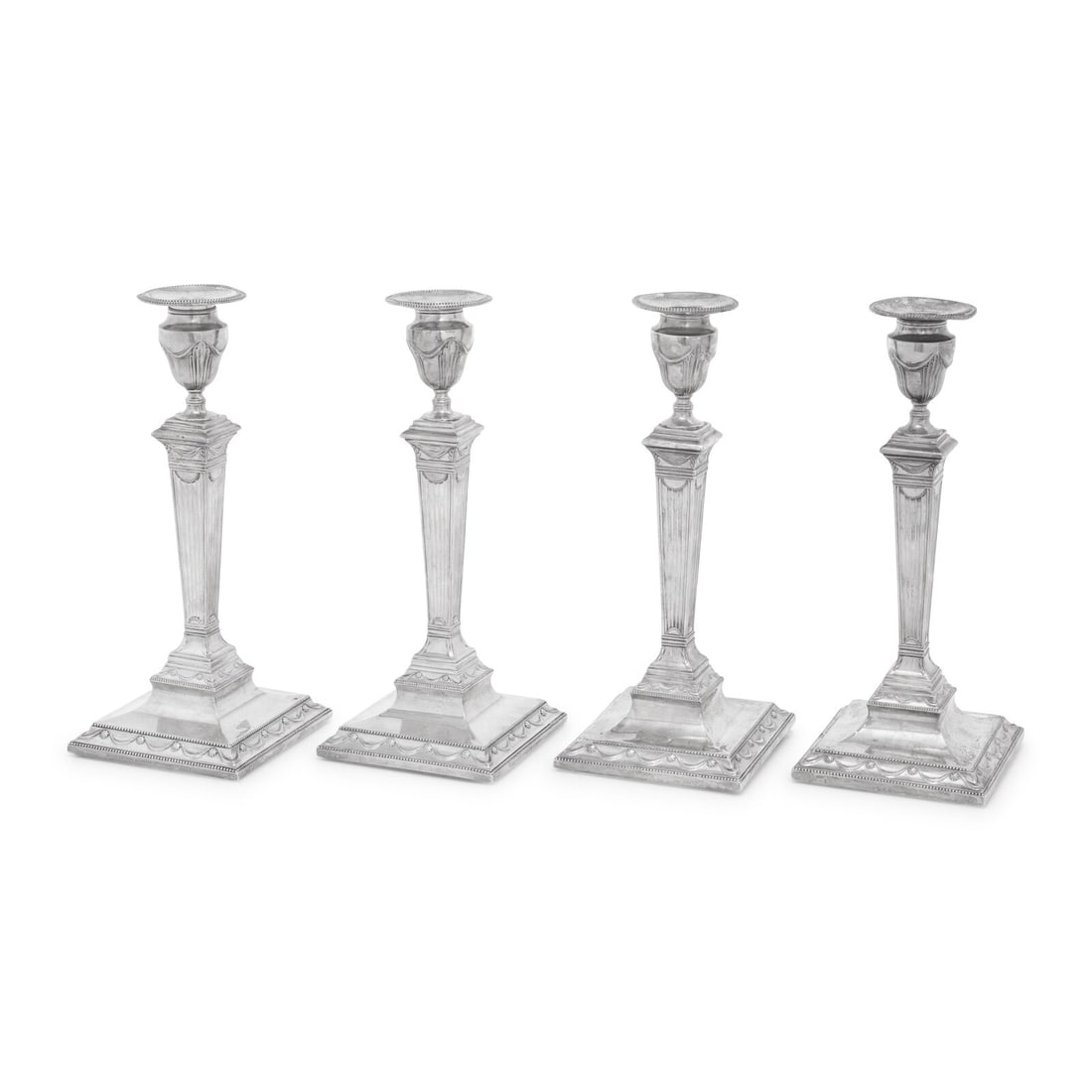 A Set of Four Neoclassical Silver Candlesticks: A Set of Four Neoclassical Silver Candlesticks Two with Marks for Fenton, Creswick and Co., 1781; Two by Tiffany and Co., After the Original weighted. Height 12 inches. This lot is located in Chicago.