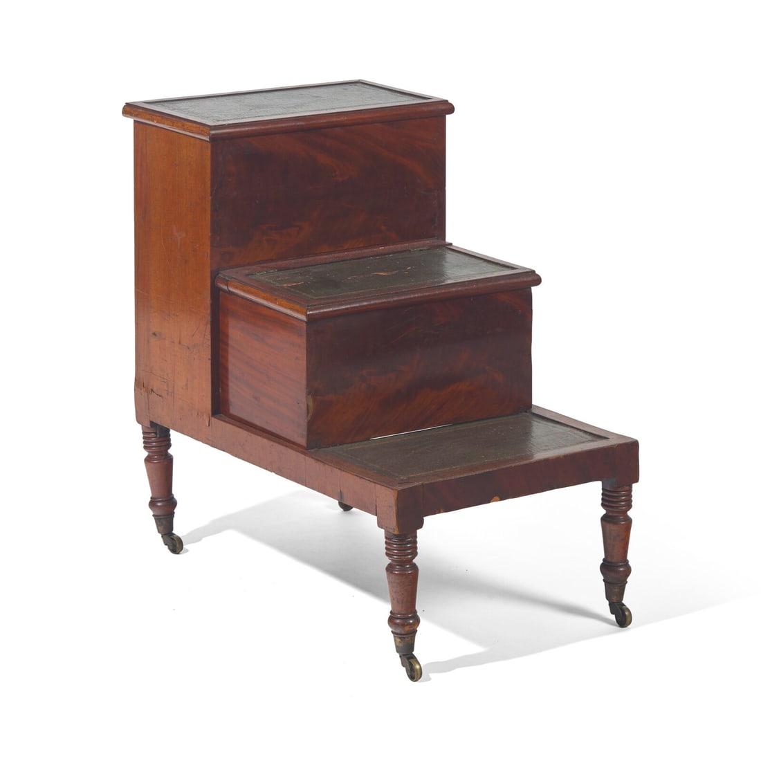 A Set of George IV Mahogany and Gilt Tooled Leather Inset Library Steps: A Set of George IV Mahogany and Gilt Tooled Leather Inset Library Steps Circa 1825 the two upper steps with lidded compartments, on turned legs with brass casters. Height 28 1/4 x width 28 1/2 x depth