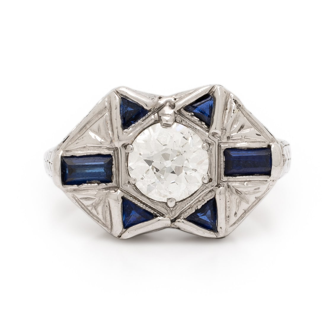 Diamond, Synthetic Sapphire, and White Gold Ring: Diamond, Synthetic Sapphire, and White Gold Ring Old European cut diamond weighing approximately 0.75 carat, and triangular and baguette cut synthetic sapphires. White gold. Ring size 6 3/4. Gross wei
