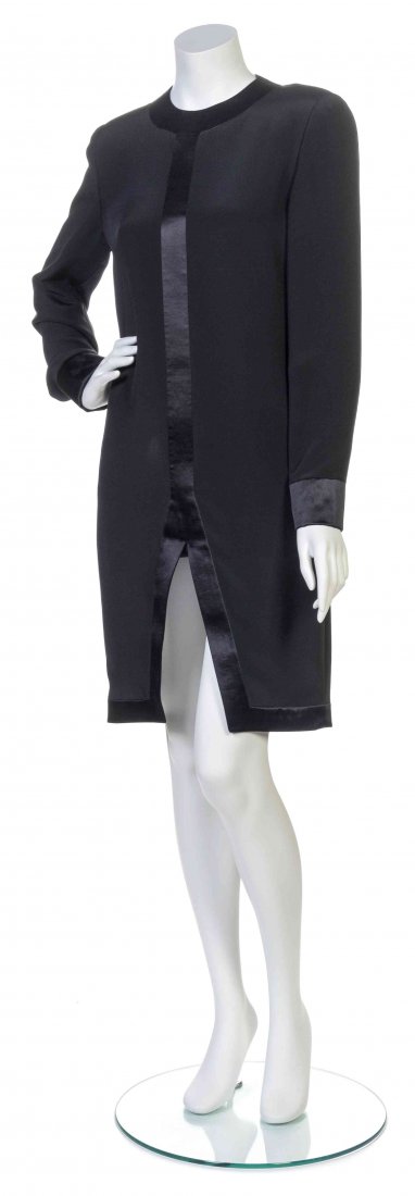 A Galanos Black Dress,: A Galanos Black Dress, long sleeves with a jewel neckline, center front split hem and black satin trim. Labeled: Galanos. Property from the Estate of Betsy Pickering Kaiser