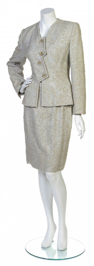 A Galanos Beige Embroidered Skirt Suit,: A Galanos Beige Embroidered Skirt Suit, comprised of an emboidered jacket with an assymetric button front closure, together with a straight skirt. Labeled: Galanos. Property from the Estate of Betsy P
