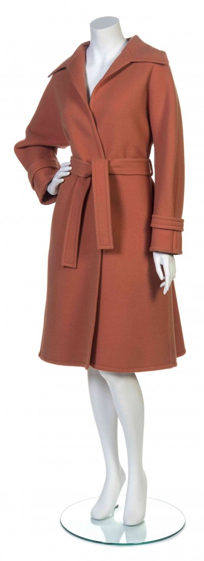 A Galanos Sienna Melton Wool Wrap Coat,: A Galanos Sienna Melton Wool Wrap Coat, with tab buttons to the sleeves and a self belt. Labeled: Galanos. Property from the Estate of Betsy Pickering Kaiser