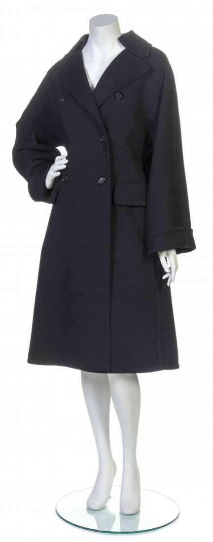 A Galanos Black Melton Wool Coat,: A Galanos Black Melton Wool Coat, double breasted, two faux patch pockets, center back box pleat. Labeled: Galanos. Property from the Estate of Betsy Pickering Kaiser