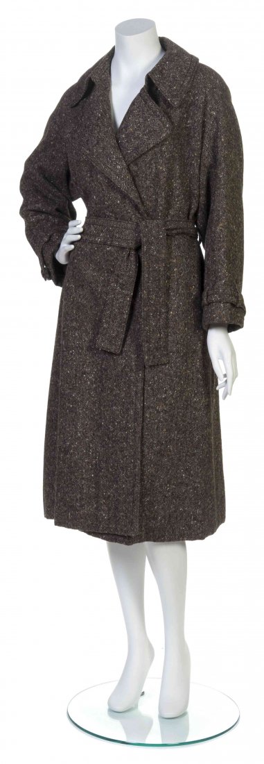 A Galanos Brown Tweed Wrap Coat,: A Galanos Brown Tweed Wrap Coat, button tabbed sleeves, with two side seam pockets, a center back inverted pleat, with a self belt. Labeled: Galanos. Property from the Estate of Betsy Pickering Kaiser